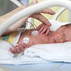 Father Dressed For Work Changing Baby's Diaper In Bedroom