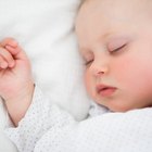 Infant sleeping on a bed
