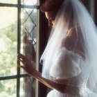 bridesmaid adjusting the bride's veil