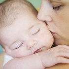 Cute baby boy in a white crib