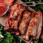 woman's hand pick up a BBQ Spare ribs