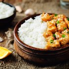 Easy fried chicken pieces in a serving dish with lemon wedges