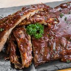 Classic BBQ ribs on parchment paper with BBQ sauce