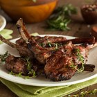 Butcher cutting beef meat on a wooden table