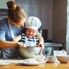 happy family in kitchen. mother and child preparing dough, bake cookies