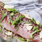 Delicious smoked ham on a wooden board with spices.