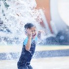 Little girl wearing water wings at a water park