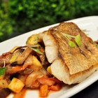 Grilled fish with lemon in pan , horizontal top view closeup