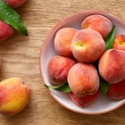 Fresh organic peaches in wooden crate viewed from above