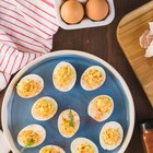 Woman holding trays of eggs, mid section, close-up