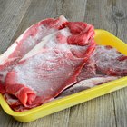 Stack of  raw steaks with rosemary