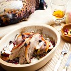 Raw chicken leg on cutting board on wooden background