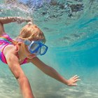 Woman with snorkel gear in water