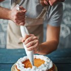 Woman with bowl of frosting