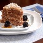 Homemade Italian cream cake garnished with pecans on a plate