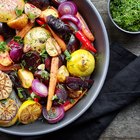 Fresh tomatoes with basil leaves in a bowl