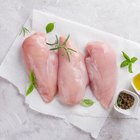 Two men grilling chicken