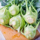 Fresh kohlrabi on the wooden table closeup