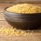 Pearl barley in a wooden spoon