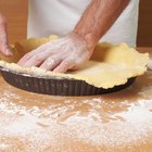 Mixing bowl, rolling pin and pie pan on kitchen counter