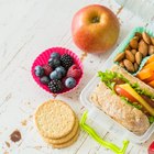 Healthy food - avokado, flax seeds, whole grain bread, nuts and apples on wooden background. Diet and healthy lifestyle concept. Vegetarian food