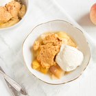 Slice of apple pie on paper on wooden table