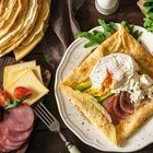 Bagel with avocado and egg on the wooden background.