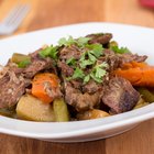 Uncooked pot roast on a bed of vegetables