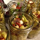 marinated cornichons in wooden bowl