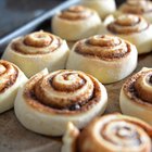 Woman making bagels, kneading dough, close up