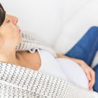 Hispanic woman holding tissue reading pregnancy test