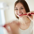 Woman shampooing hair and smiling