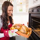 baked whole chicken with oranges on plate. horizontal top view