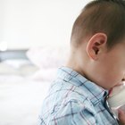 Mother holding a baby and bottle with breast milk