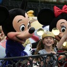 Pedestrians crossing sunlit street at Disneyland