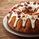 A kitchen knife slicing through a golden-brown pound cake.