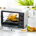 Woman removing cookies from oven