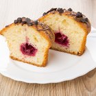 Strawberry cake in a white serving dish on a wooden surface