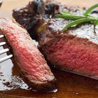 Beef Steak. Roasted Beef steak with salt pepper thyme on rustic wooden table
