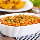 white beans in tomato sauce in a wooden bowl