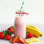 Father and daughter preparing smoothie in kitchen