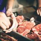 Sliced grilled medium rare beef steak served on wooden board Barbecue, bbq meat beef tenderloin. Top view, slate background