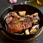 Sliced grilled medium rare beef steak served on wooden board Barbecue, bbq meat beef tenderloin. Top view, slate background