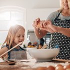 Woman's hands kneading dough in a kitchen