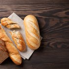 Homemade bread with spikelet of wheat on cloth on boards