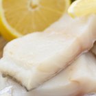 Close-up of a cod fillet with rosemary on a plate