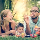 Girl (5-7 years) and boy (9-11 years) in tent with parents, mother reading story