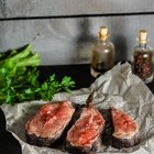 Female chef garnishing a plate with steak