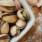 Bowl with pistachios on the table. Top view.