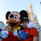 Pedestrians crossing sunlit street at Disneyland